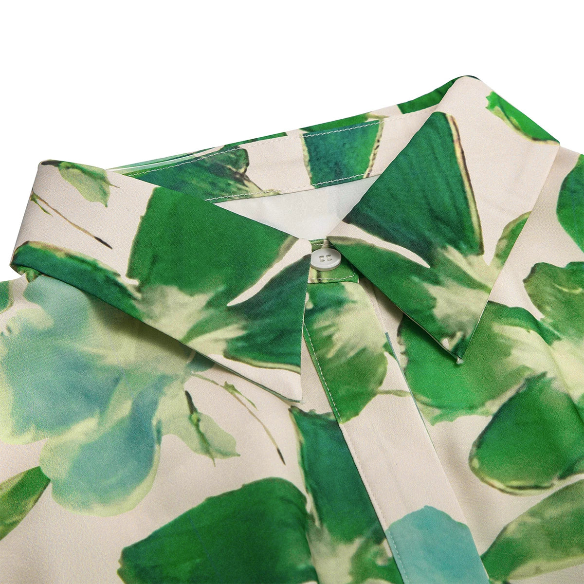 Green leaf patterned shirt on a white background
