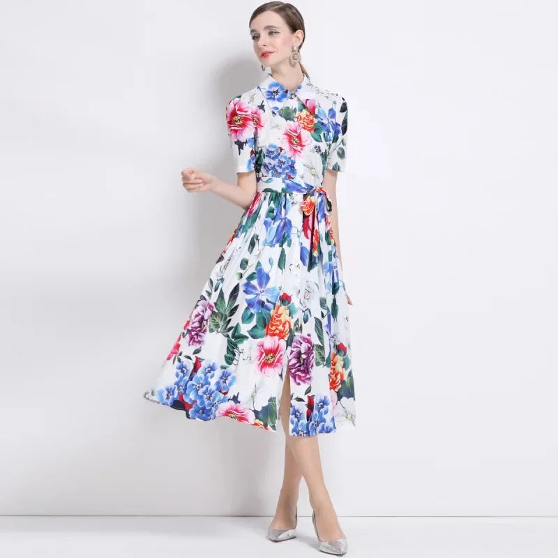 Woman wearing a colorful floral dress against a white background