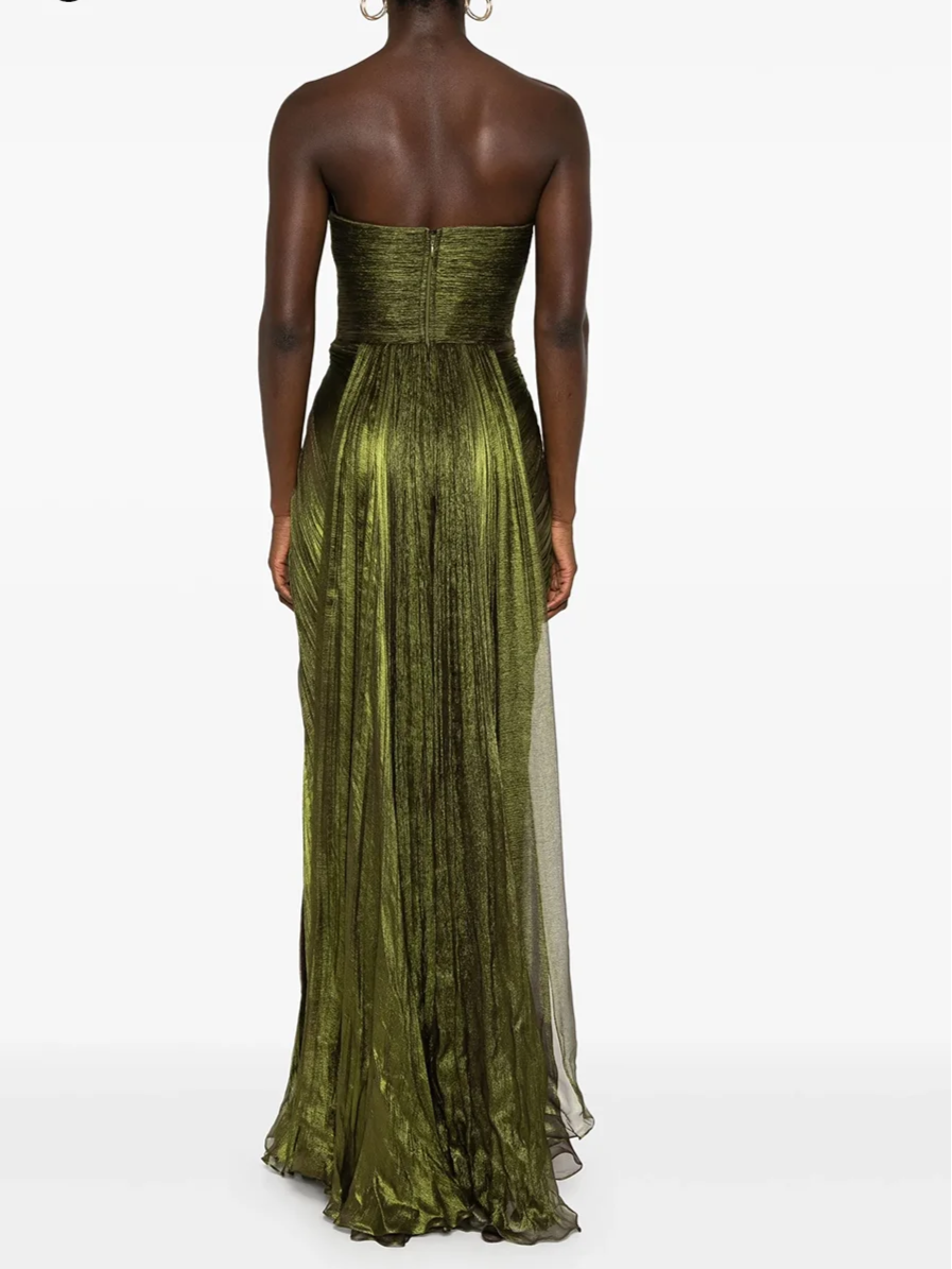 Woman wearing a strapless green dress with a white background