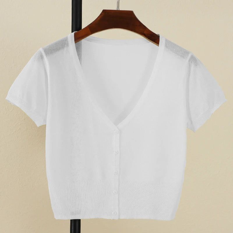 White blouse on a hanger against a beige background