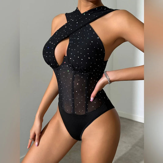 Black swimsuit with star patterns on a plain background