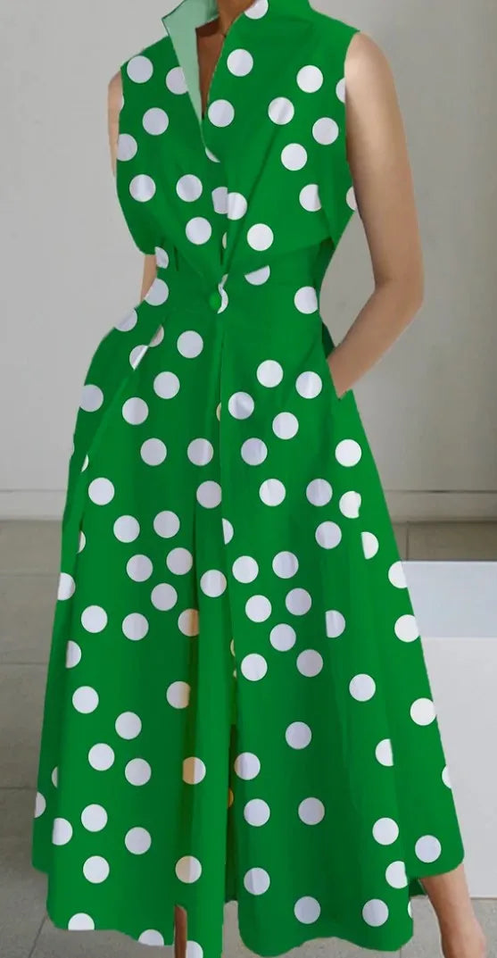 Green dress with white polka dots on a plain background