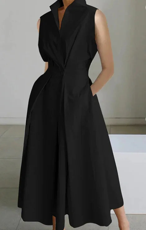 Black sleeveless dress worn by a person on a neutral background