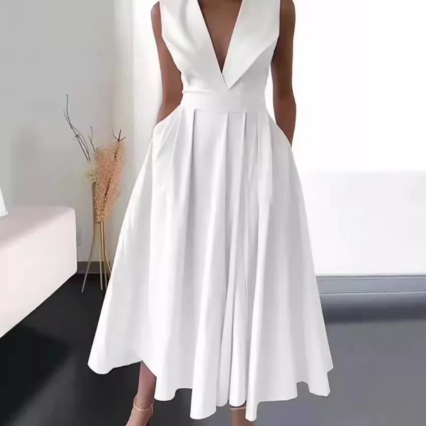 White dress with a deep neckline and cut-out sides on a neutral background