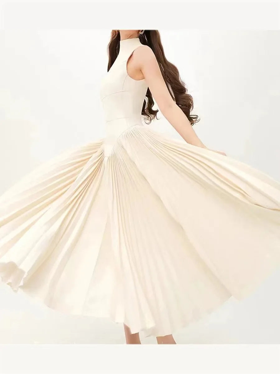 Woman wearing a flowing beige dress on a white background