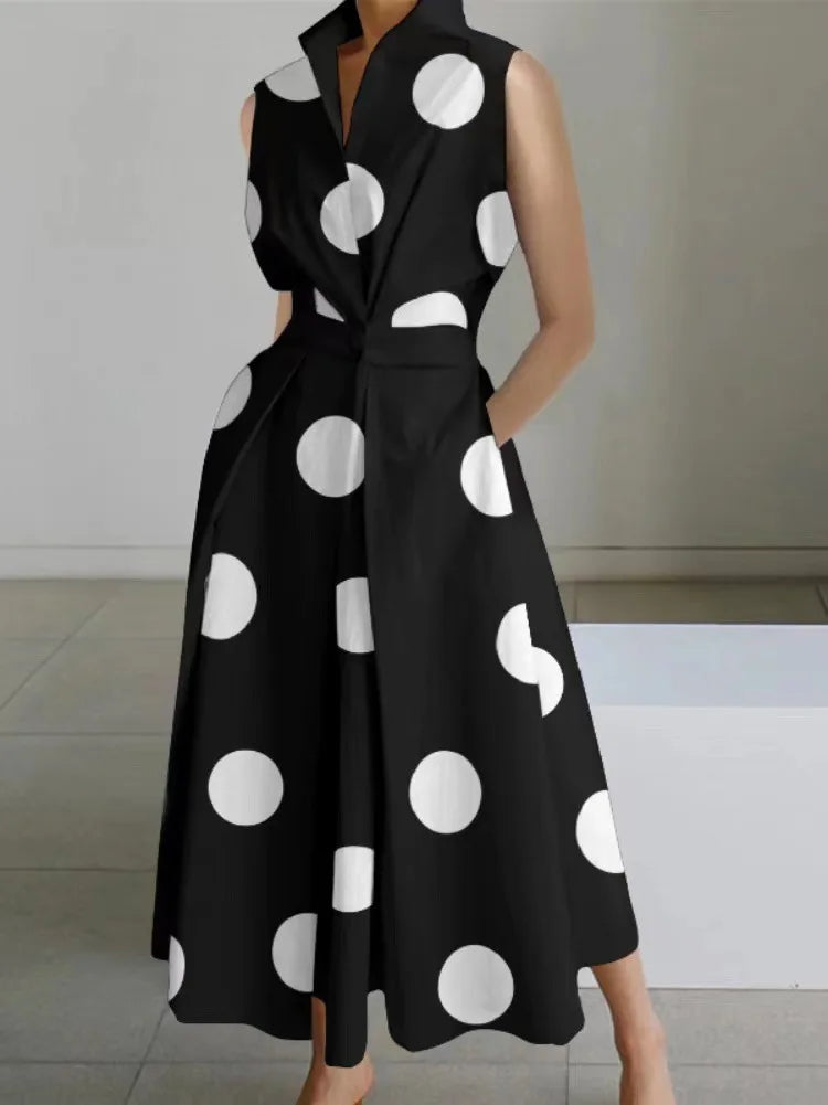 Black dress with white polka dots on a neutral background