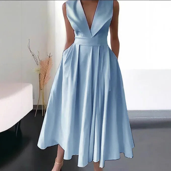 Light blue dress with a plunging neckline on a plain background