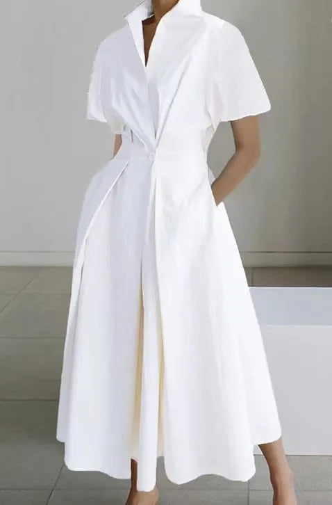 White dress worn by a person on a plain background