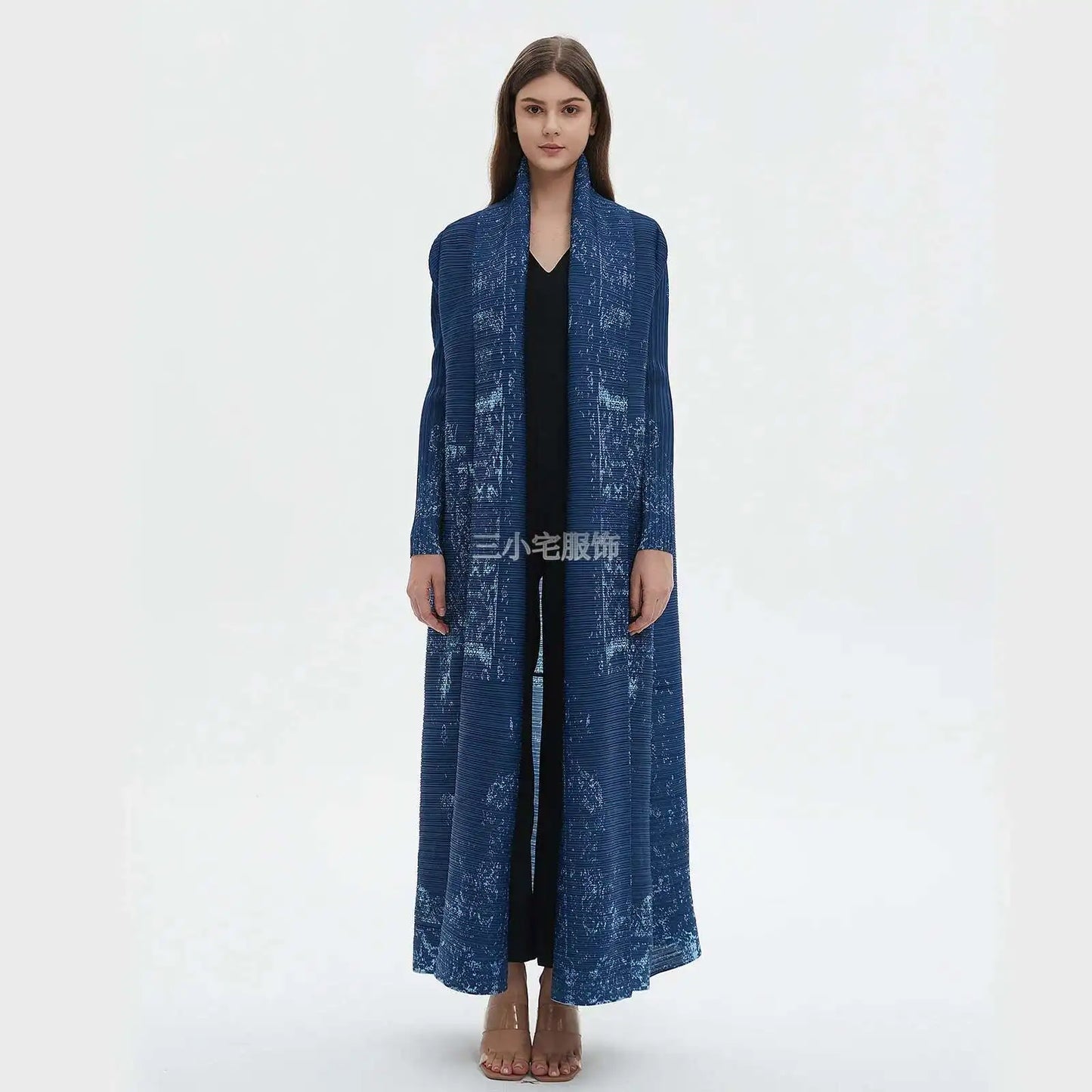Woman wearing a long blue coat on a white background