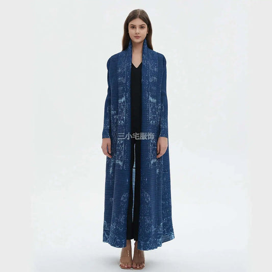 Woman wearing a long blue coat on a white background