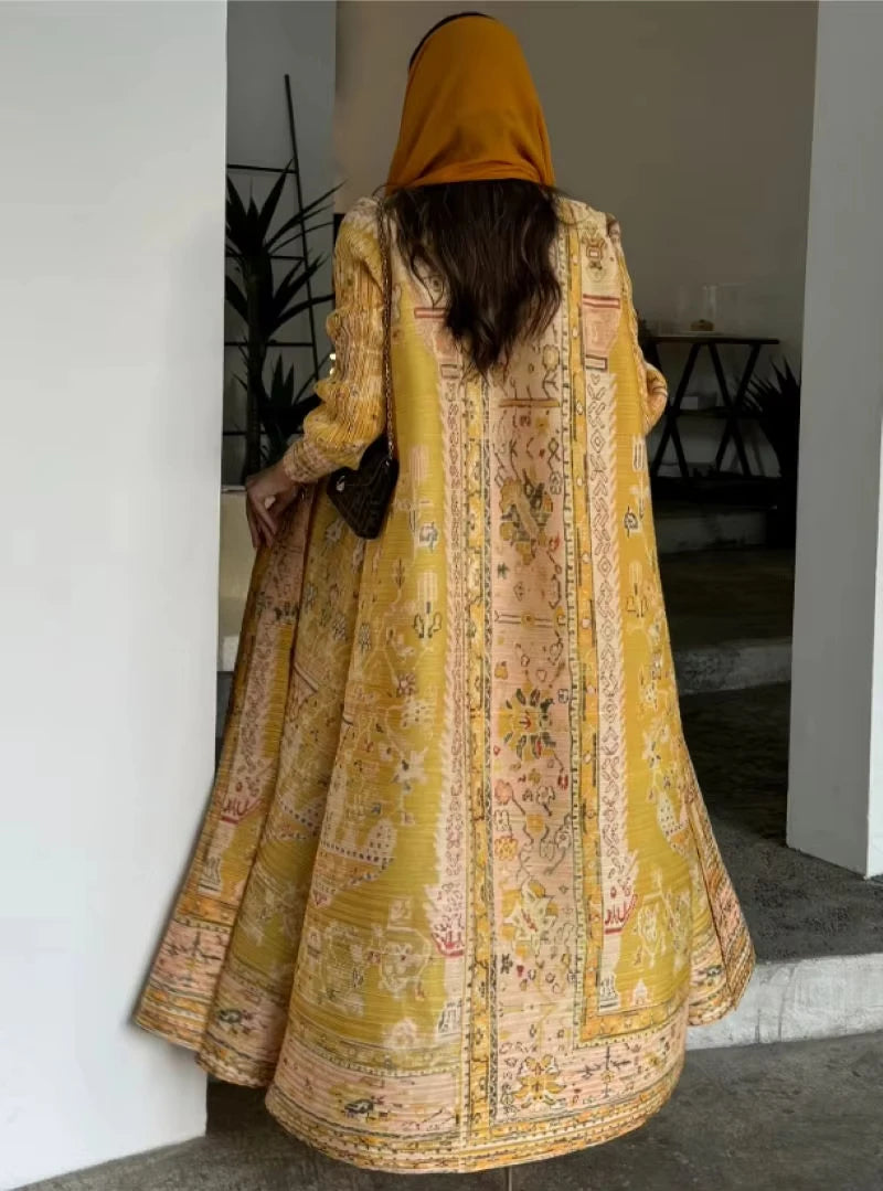 Person wearing a yellow and patterned long garment indoors.