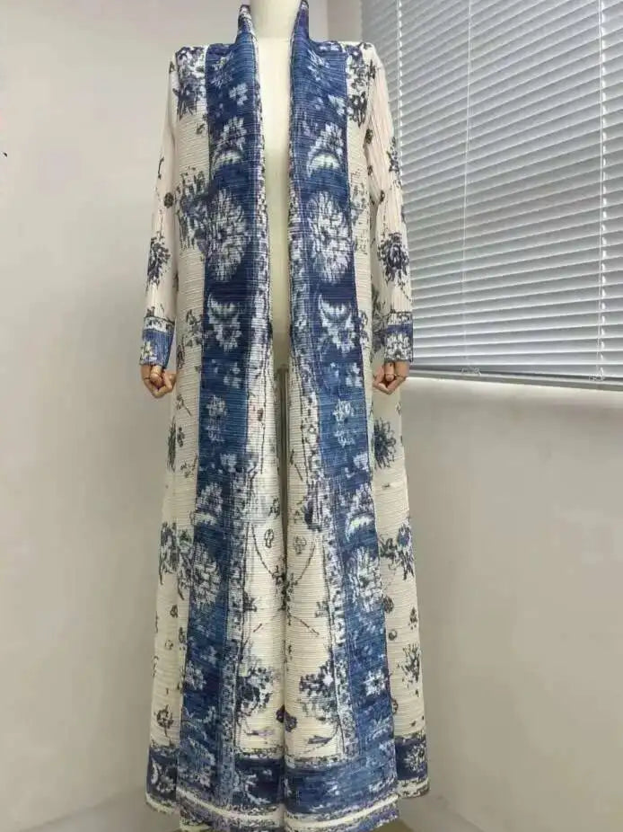 Long blue and white floral patterned dress on a mannequin against a white wall.