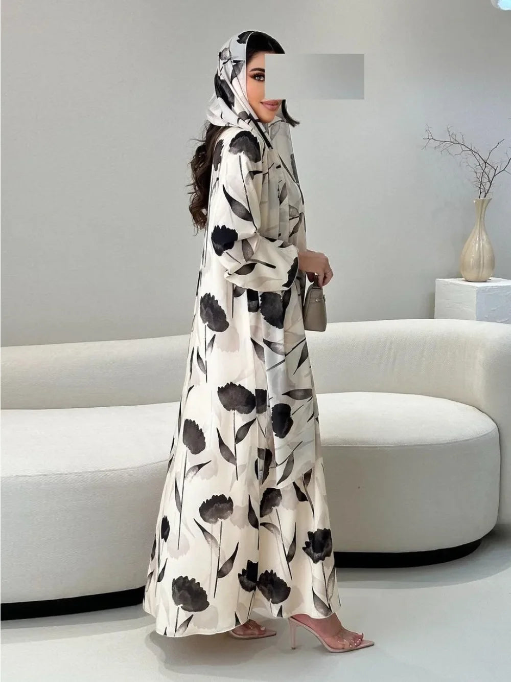 Woman wearing a long, floral-patterned dress in a modern living room.