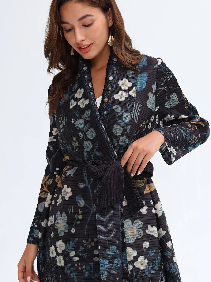 Woman wearing a dark floral patterned robe against a white background