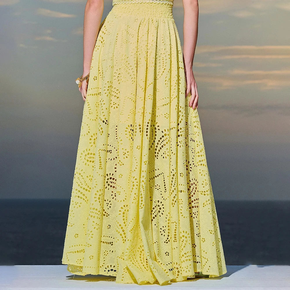 Yellow lace dress worn by a person with a blurred background
