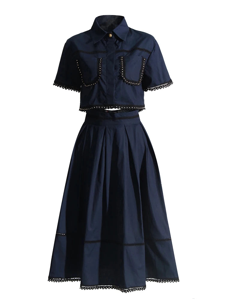 Navy blue outfit with short-sleeve top and full skirt on a white background
