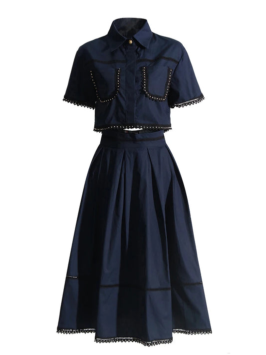 Navy blue outfit with short-sleeve top and full skirt on a white background