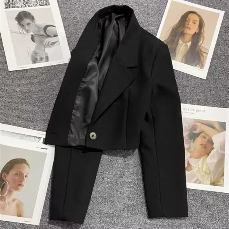 Black blazer and pants on a textured surface with blurred portrait images in the background