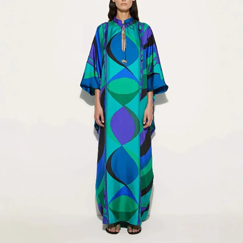 Woman wearing a colorful dress with geometric pattern on a white background