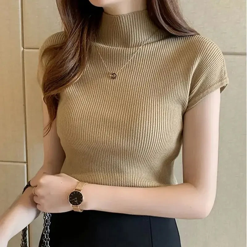 Woman wearing a beige ribbed top with a neutral background