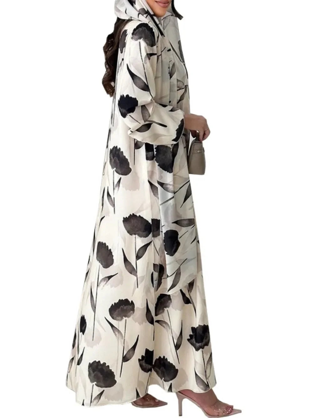 Woman wearing a long, floral-patterned dress on a white background