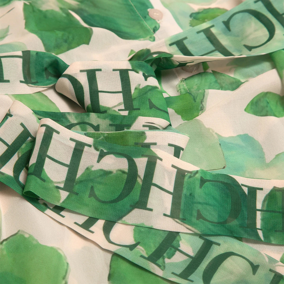 Green fabric with printed text on a beige background