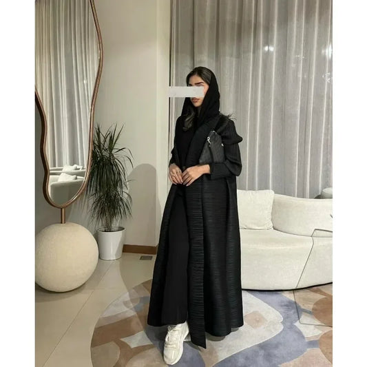 Person wearing a black outfit in a modern living room.