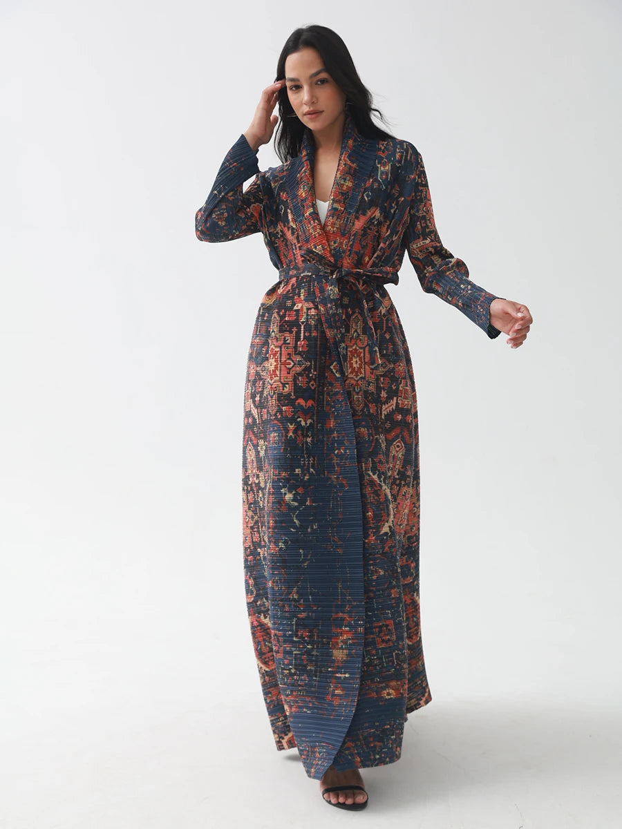 Woman wearing a long, patterned dress on a white background