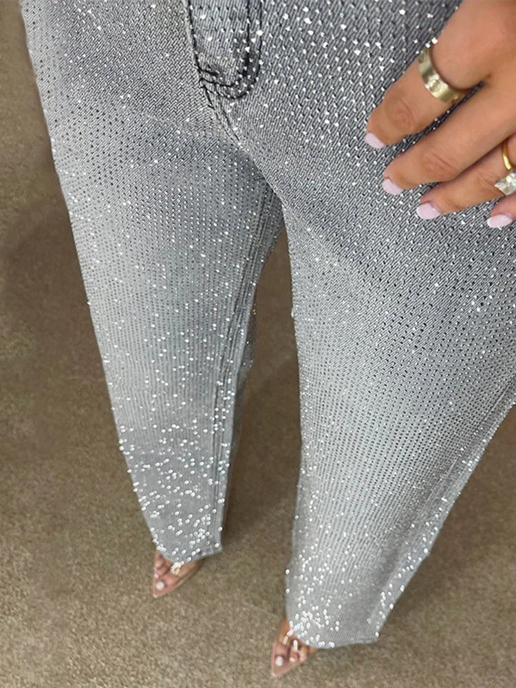 Silver sequin pants being worn on a neutral background