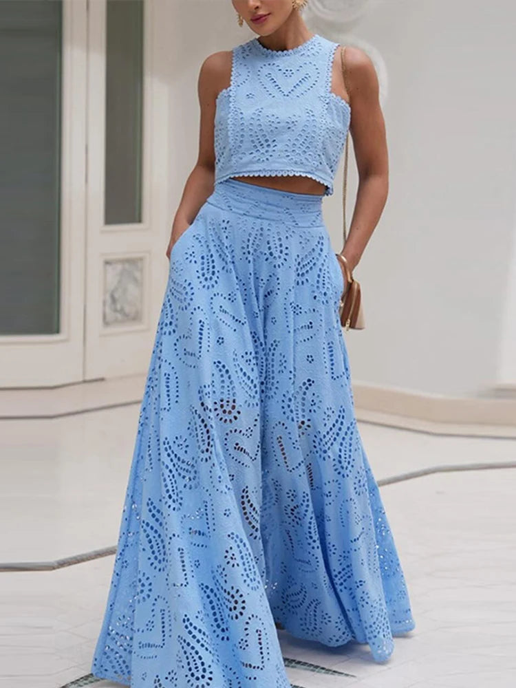 Woman wearing a blue lace two-piece outfit indoors.
