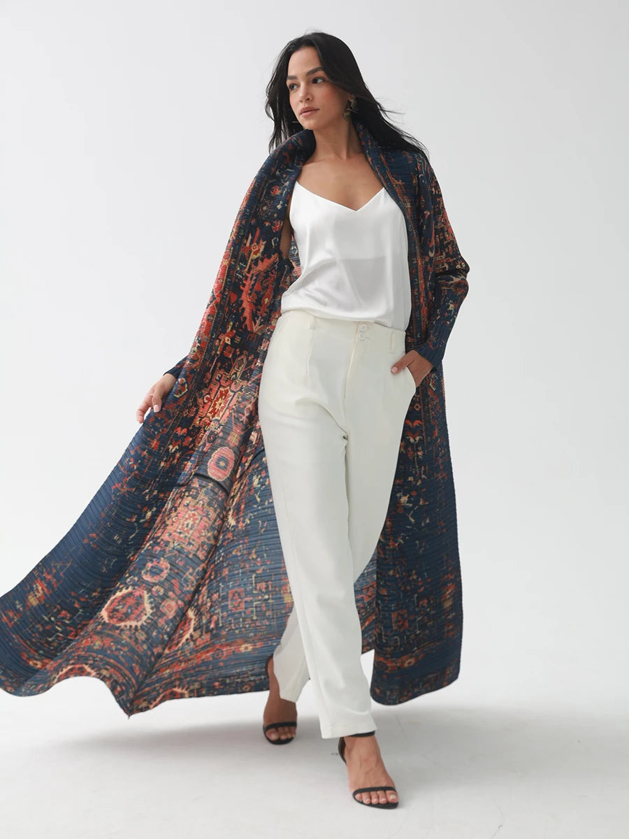 Woman wearing a long, patterned scarf over a white outfit on a white background