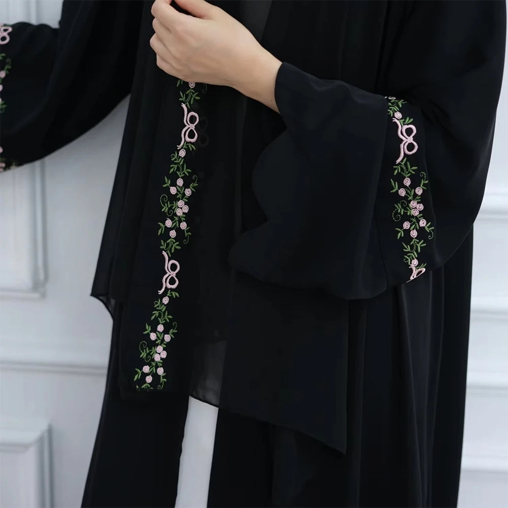 Black garment with floral embroidery on a white background