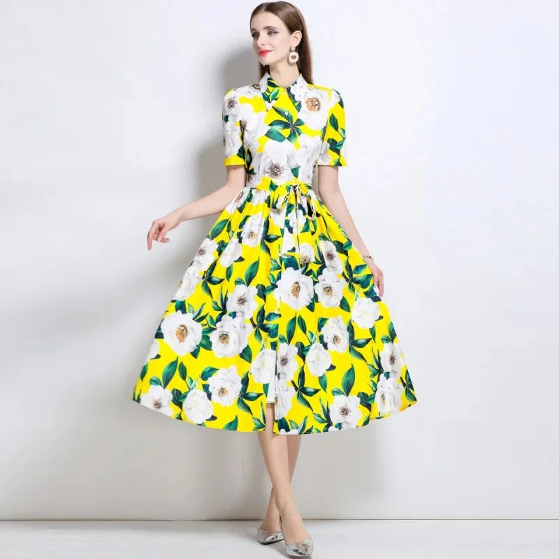 Woman wearing a floral dress with yellow and white flowers on a plain background