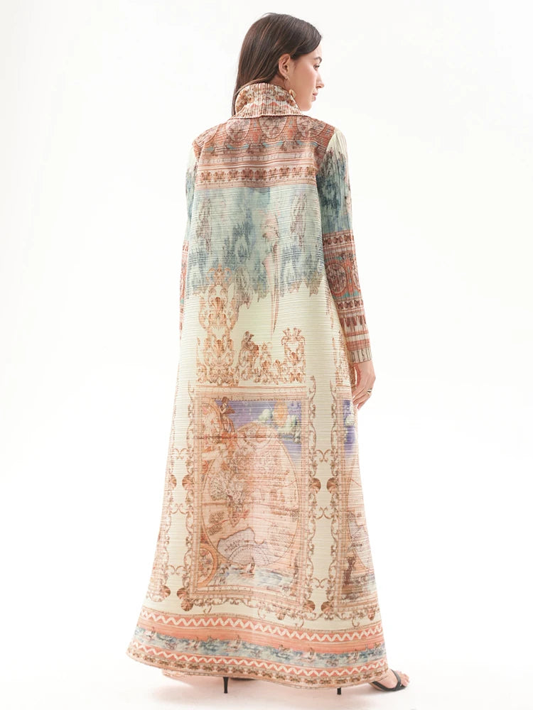 Woman wearing a long, patterned dress with a white background