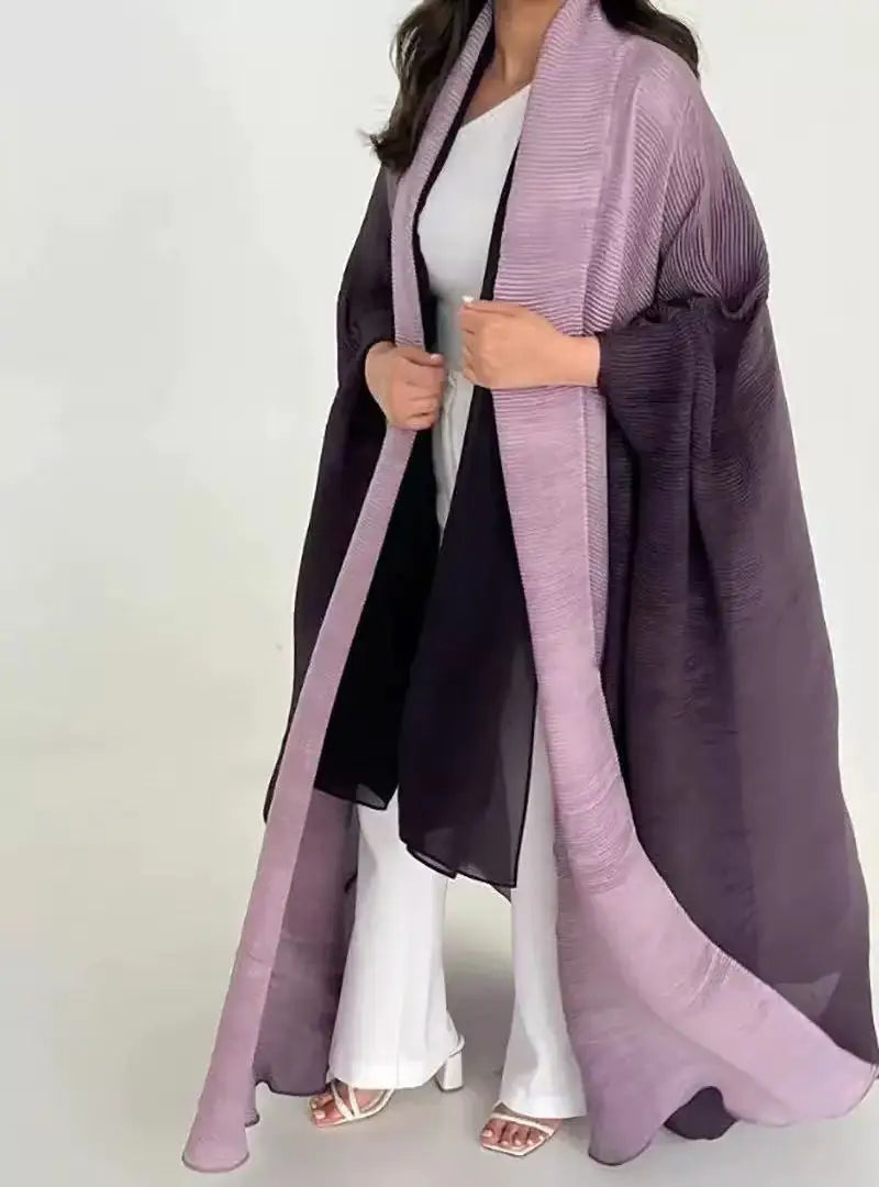 Person wearing a long, light purple scarf over a dark outfit on a white background