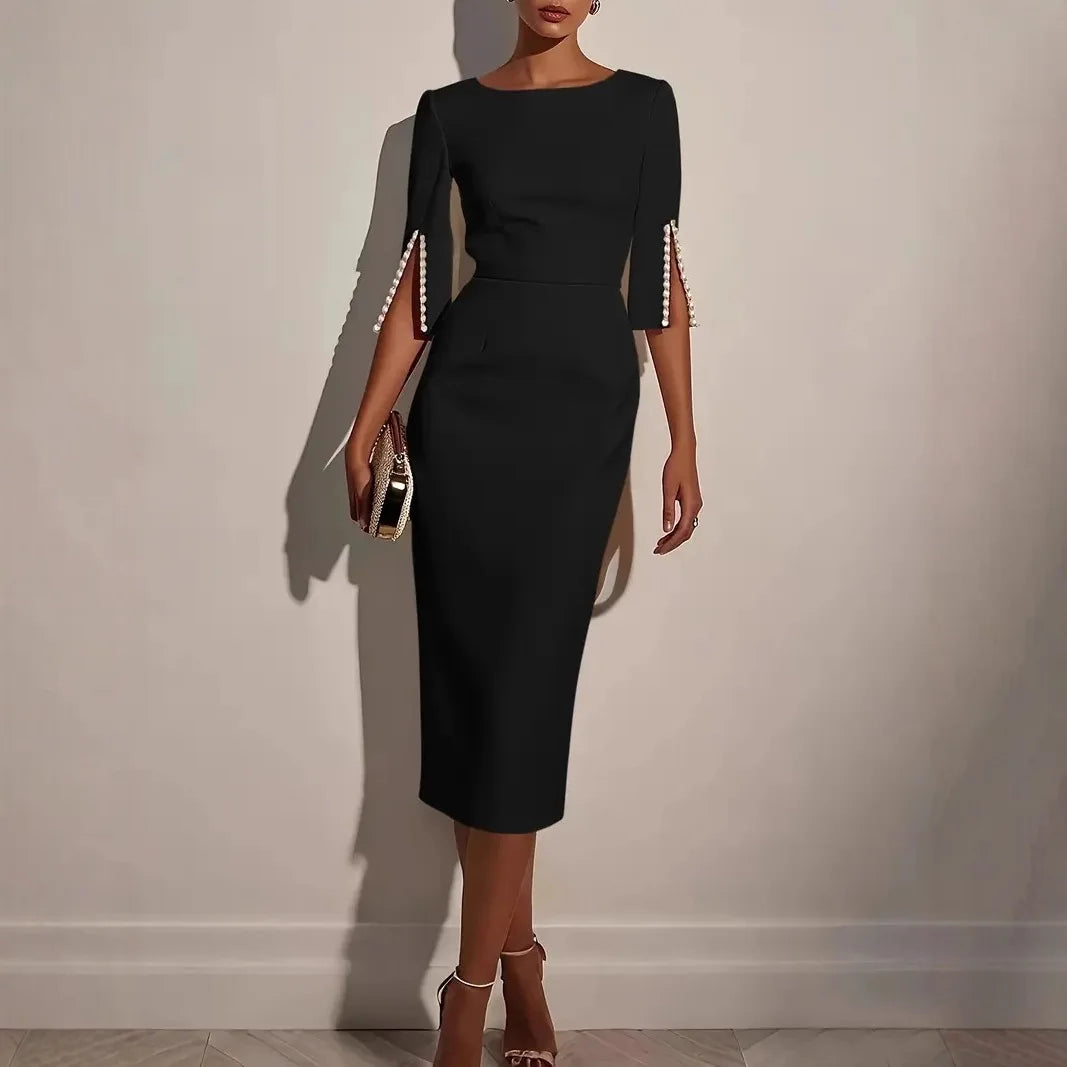 Black dress with unique sleeve designs worn by a model against a plain background
