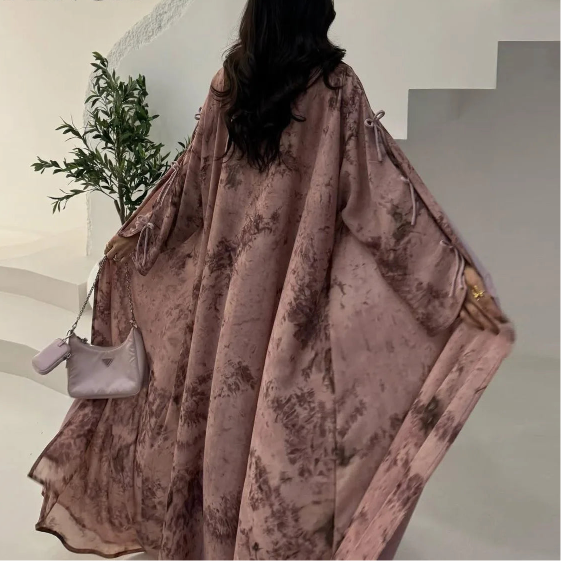 Person wearing a patterned shawl with 'CPENGA' branding in the corner.