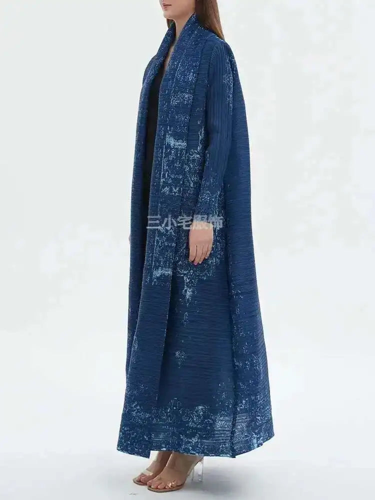 Long blue coat worn by a person on a white background