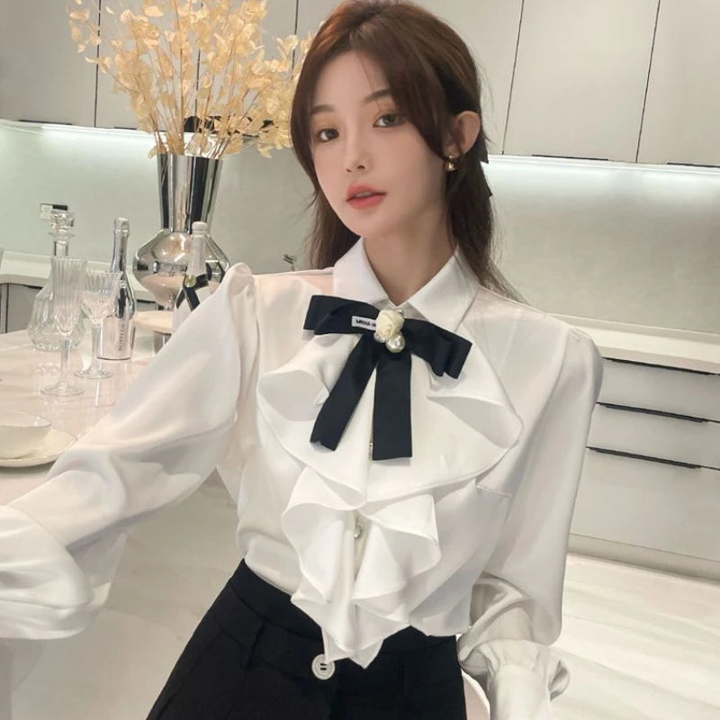 Woman wearing a white blouse with a black bow