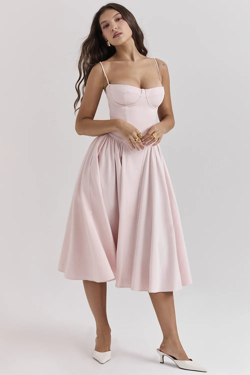 Woman wearing a pink dress on a white background