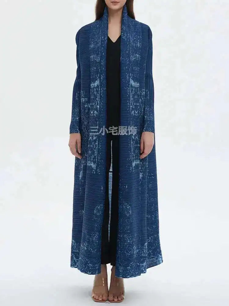 Person wearing a long blue textured coat on a white background