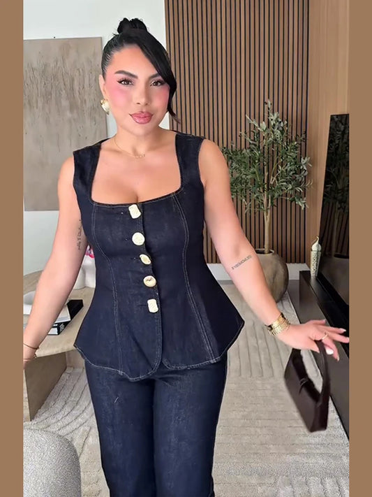Woman wearing a denim outfit with a buttoned top in an indoor setting