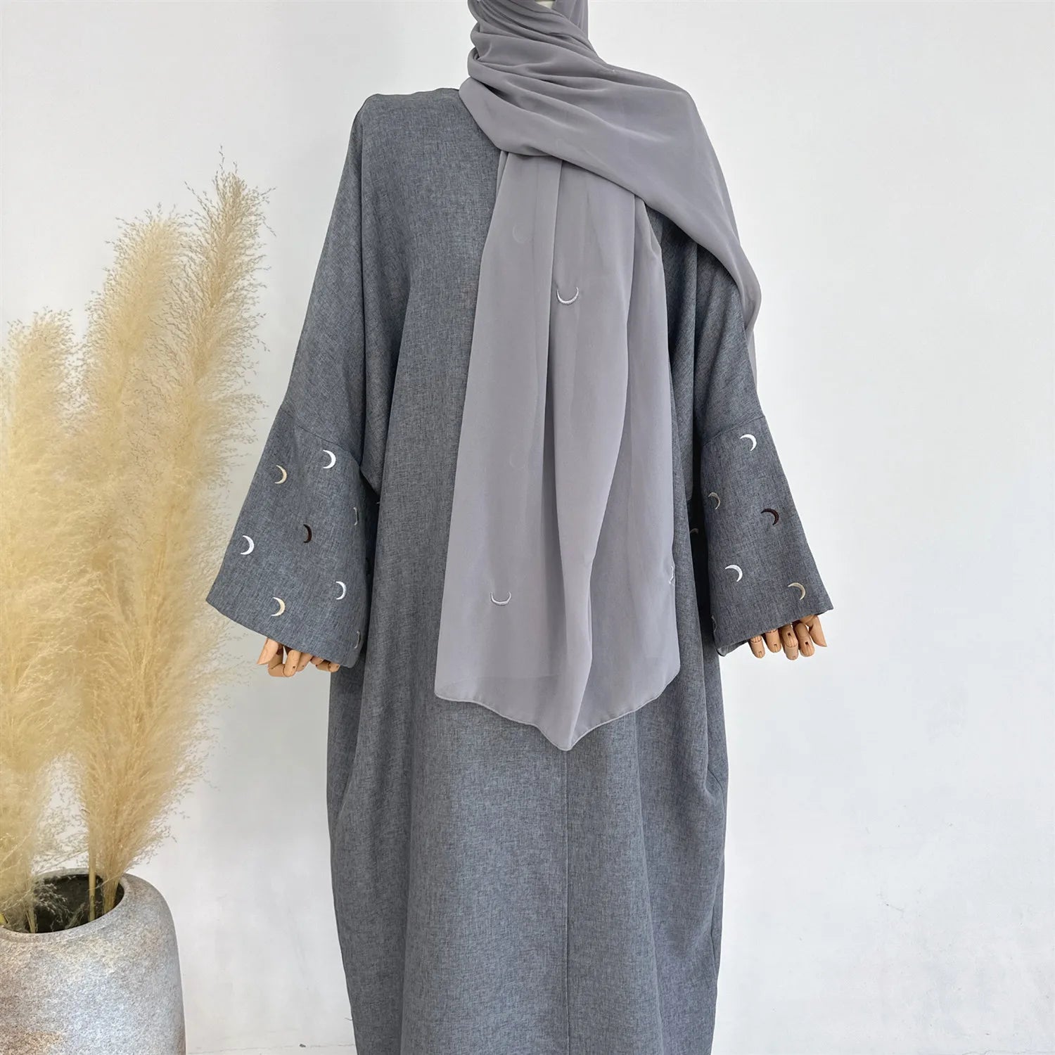 Gray abaya with decorative sleeves on a white background