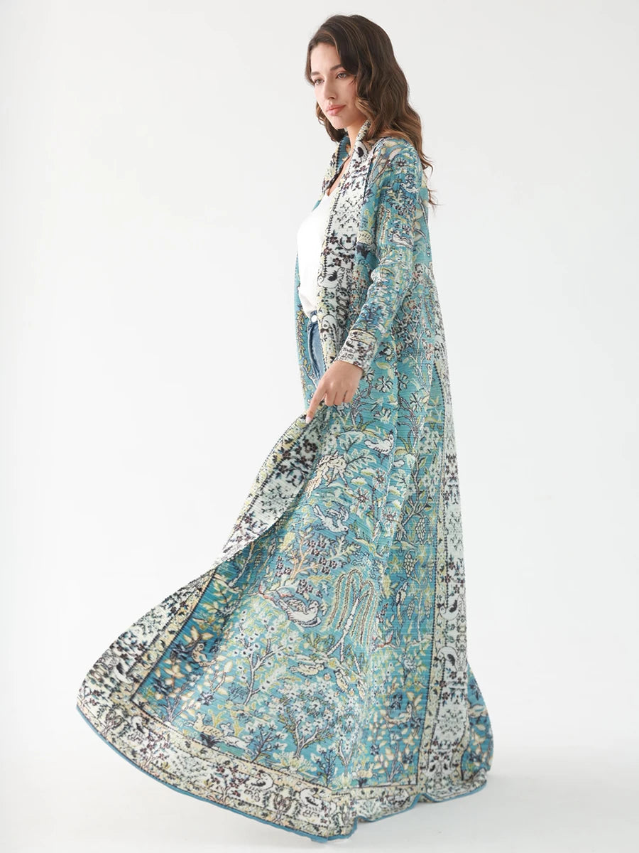 Woman wearing a long, light blue floral dress with a white background