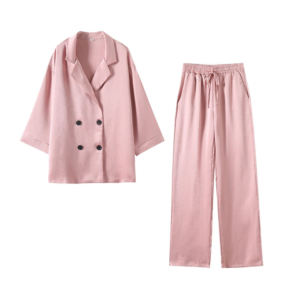 Pink pajama set with a jacket and pants on a white background