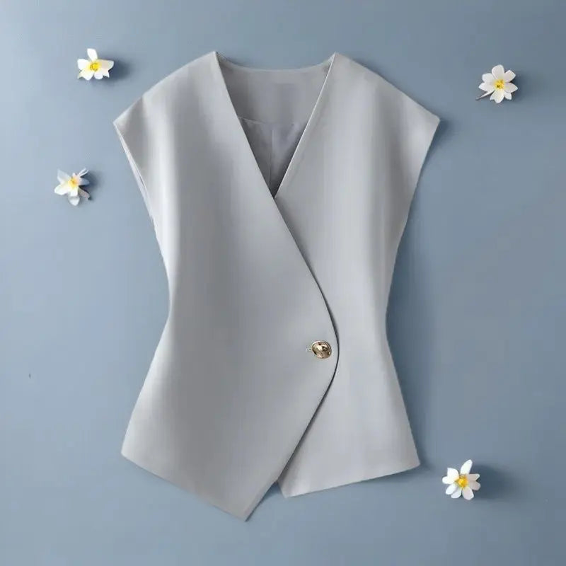 Light gray sleeveless blazer on a blue background with white flowers.
