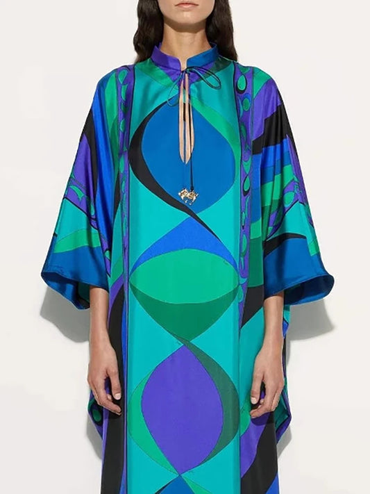 Colorful patterned dress worn by a model on a white background