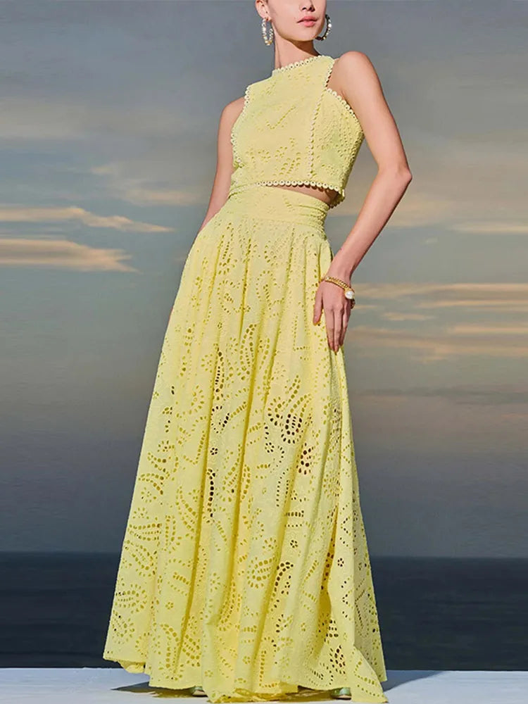 Woman wearing a yellow lace dress against a blurred natural background