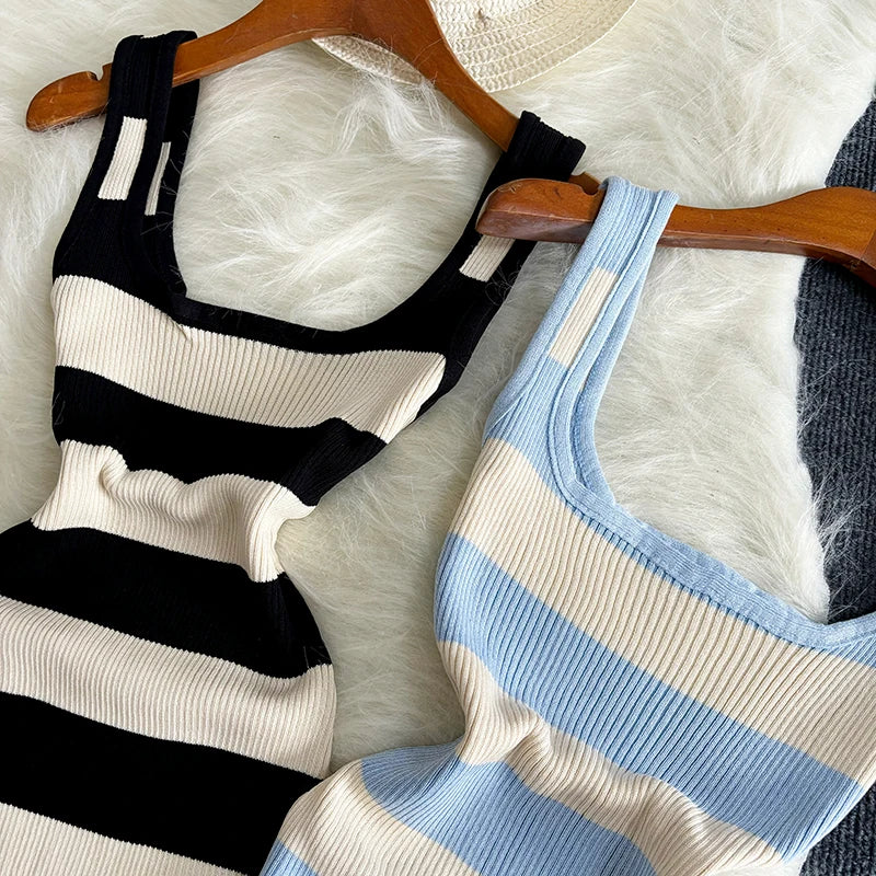 Two striped tank tops on hangers against a white background