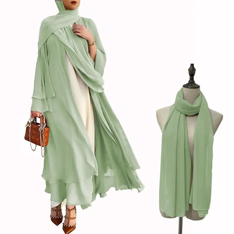 Light green hijab worn by a person and draped over a mannequin on a white background